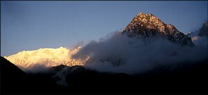 The dying sun picks out the peaks above the clouds at Tseram