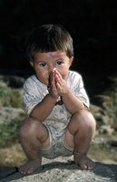 Young child gives the traditional Nepalese greeting - Namaste!